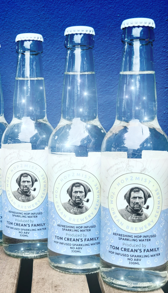 Three bottles of Hop2mist Hop Infused Sparkling Water made by Tom Crean's Brewery, each containing water sparkling like starlight.